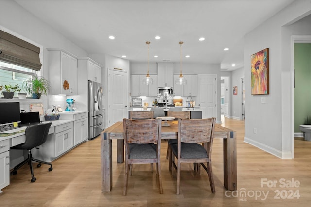 dining area with light hardwood / wood-style floors