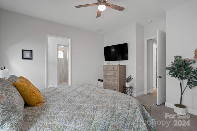 bedroom with carpet floors, ensuite bathroom, and ceiling fan