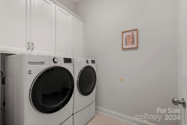 laundry room with cabinets and washing machine and dryer