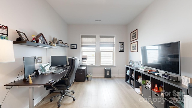 office area with light hardwood / wood-style floors and a wealth of natural light