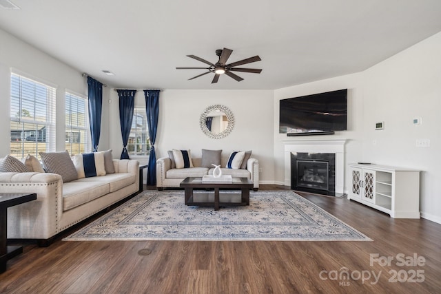 living room with ceiling fan and dark hardwood / wood-style floors