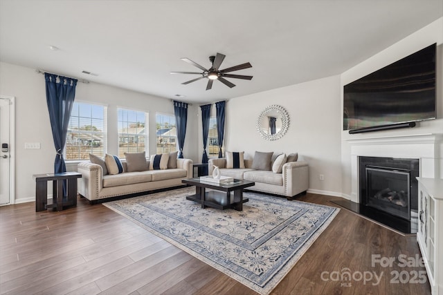 living room featuring dark hardwood / wood-style flooring and ceiling fan