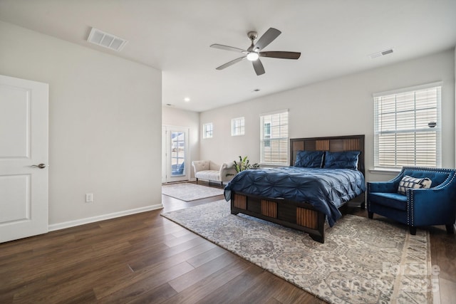 bedroom with dark hardwood / wood-style floors and ceiling fan