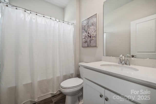 full bathroom featuring vanity, shower / bath combination with curtain, and toilet