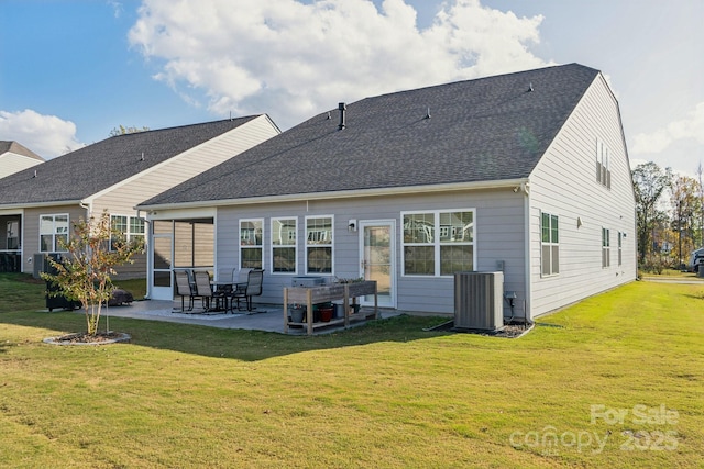 rear view of property featuring central AC unit, a patio, and a lawn