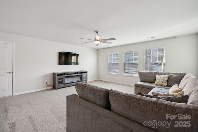 carpeted living room featuring ceiling fan