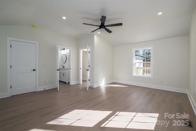 interior space featuring lofted ceiling, hardwood / wood-style floors, sink, and ceiling fan