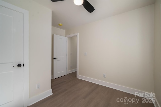 unfurnished bedroom featuring ceiling fan and dark hardwood / wood-style floors