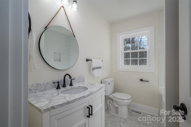 bathroom with vanity, tile patterned floors, and toilet