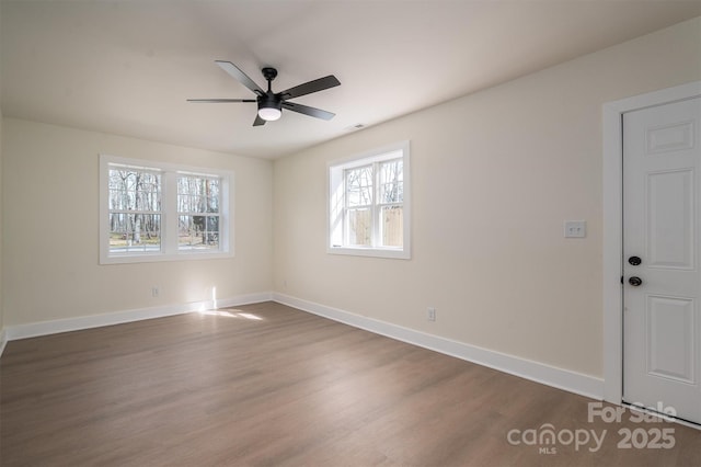 empty room featuring dark wood-type flooring and ceiling fan