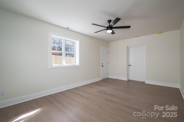 spare room with hardwood / wood-style floors and ceiling fan