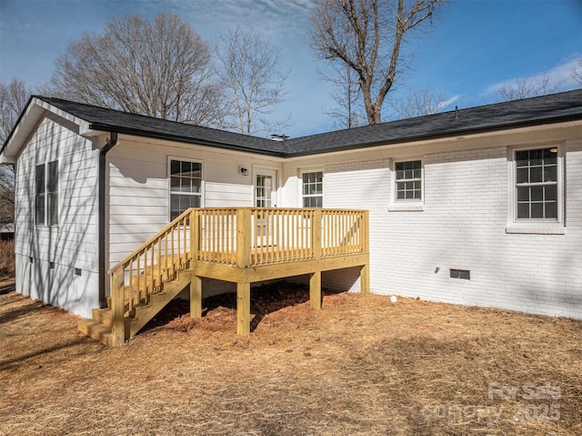 back of house with a deck