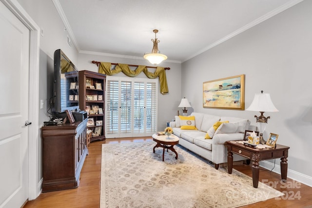 living room with ornamental molding and light wood-type flooring