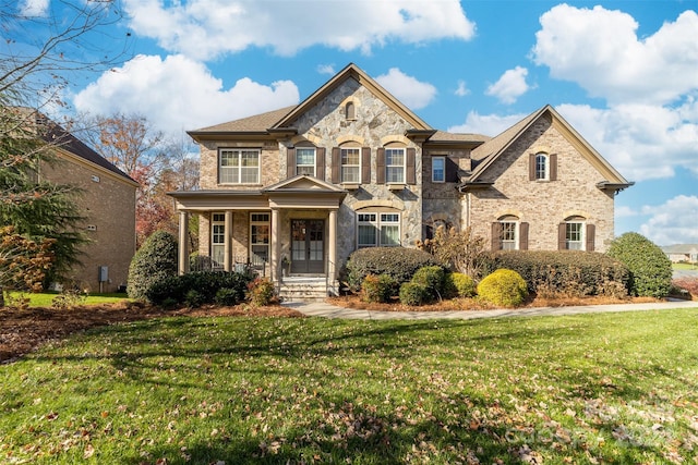 view of front of house with a front yard and a porch