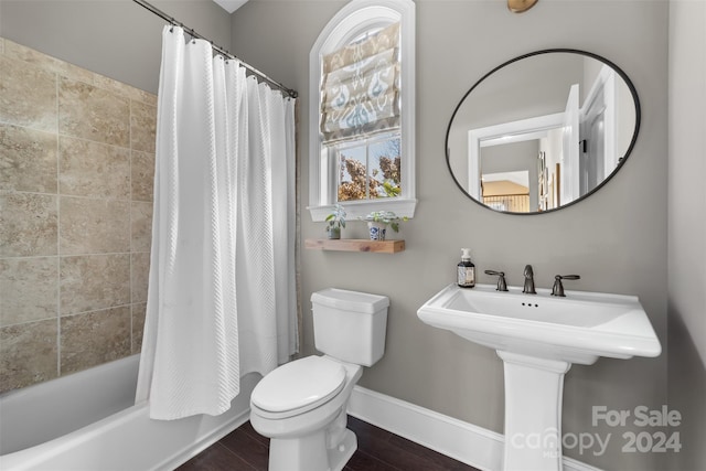 full bathroom with sink, wood-type flooring, shower / tub combo, and toilet