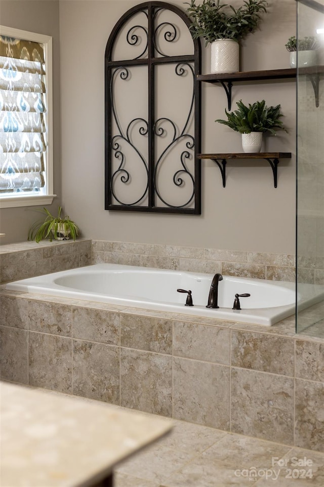 bathroom featuring a relaxing tiled tub