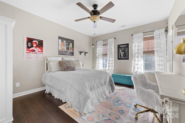 bedroom with ceiling fan and dark wood-type flooring