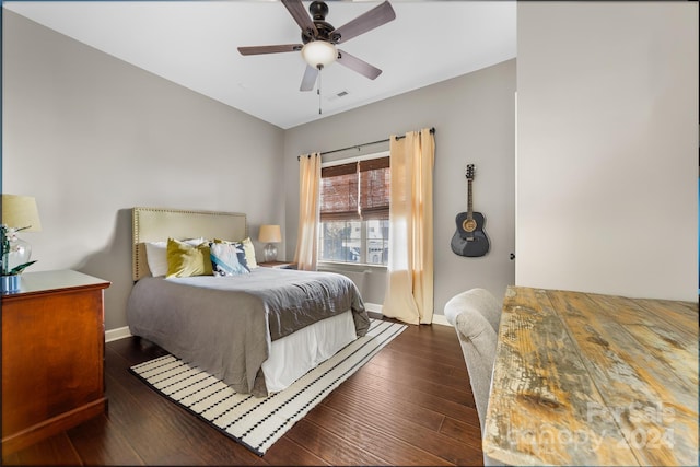 bedroom featuring ceiling fan, dark hardwood / wood-style flooring, and vaulted ceiling