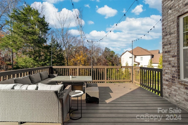 wooden terrace with an outdoor hangout area