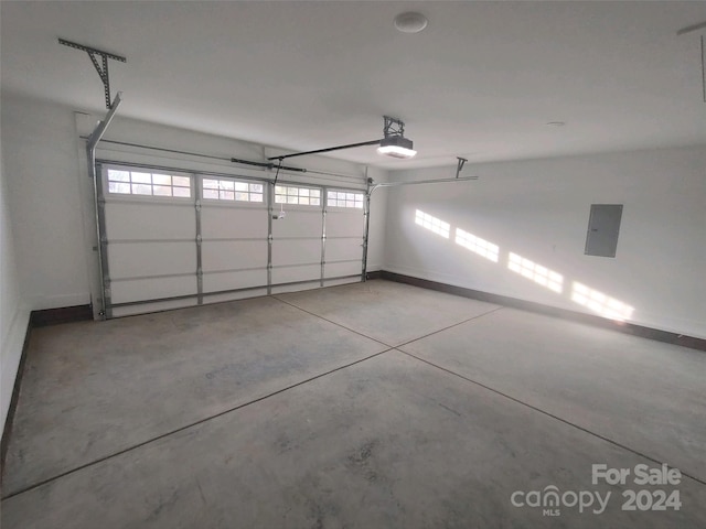 garage with electric panel and a garage door opener