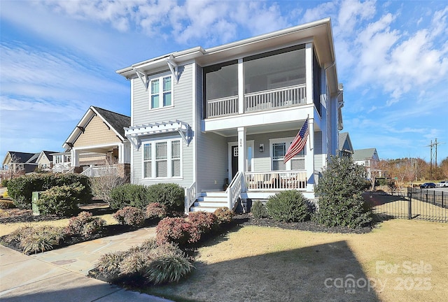 view of front of house with a porch and fence