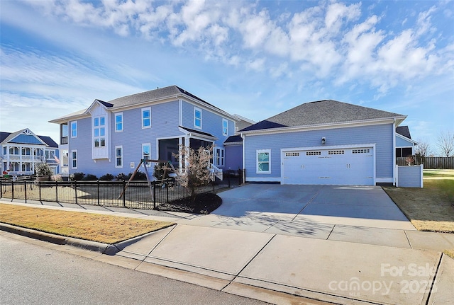 view of front of property with a garage, driveway, and fence