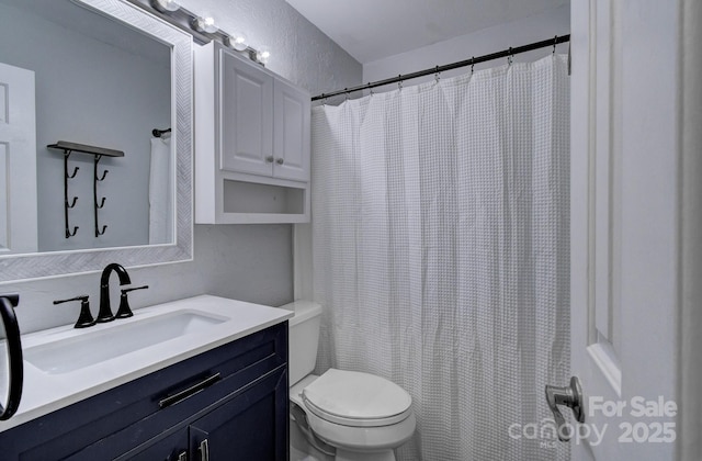 bathroom with toilet, vanity, and a shower with curtain