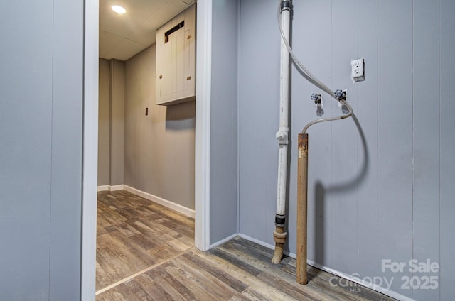 interior details with a barn door and hardwood / wood-style floors