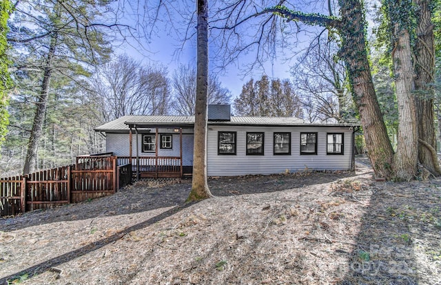 ranch-style home with a wooden deck