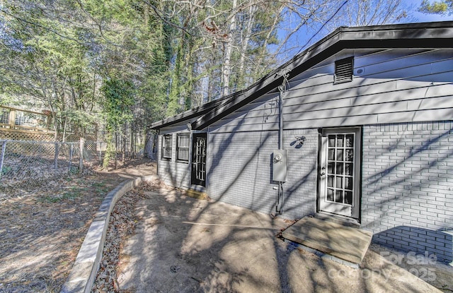 view of side of home featuring a patio area