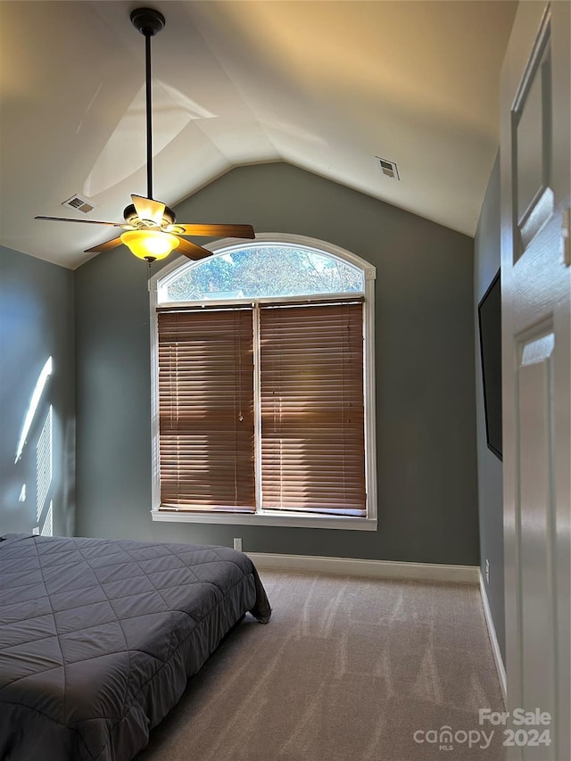 unfurnished bedroom featuring carpet, ceiling fan, and lofted ceiling