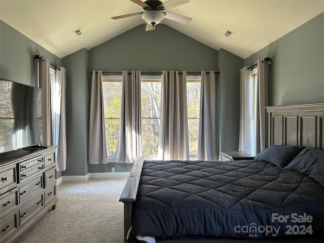 bedroom with ceiling fan, light colored carpet, and vaulted ceiling