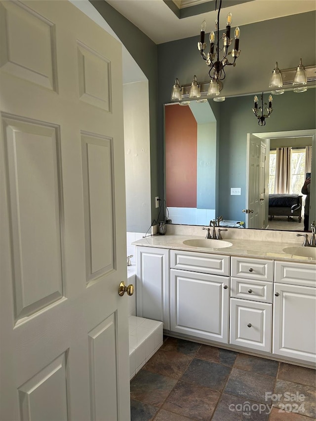 bathroom with vanity and a notable chandelier