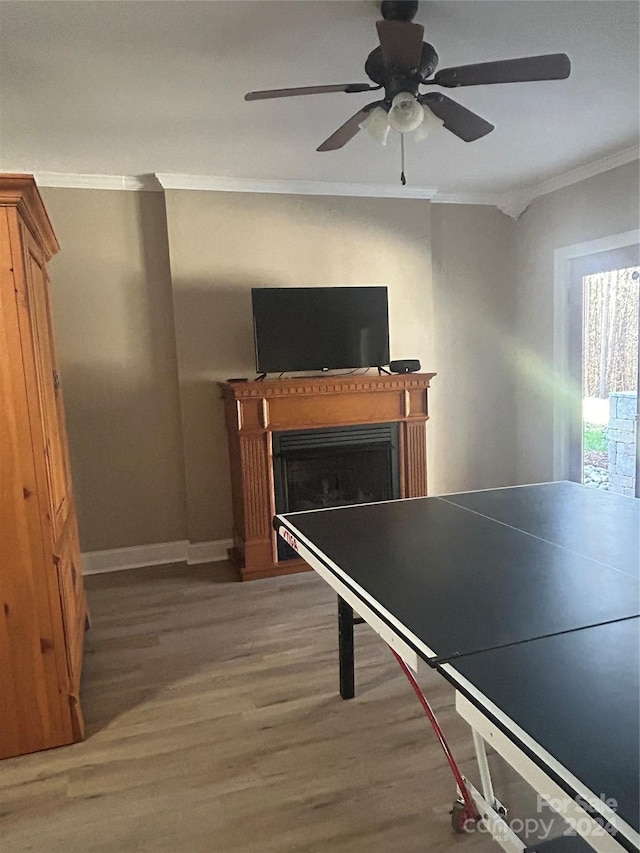 playroom featuring hardwood / wood-style floors, ceiling fan, and ornamental molding