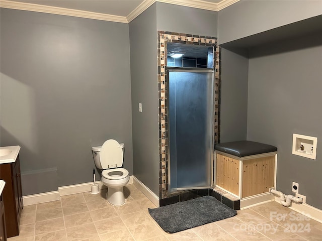 bathroom featuring tile patterned floors, crown molding, vanity, and toilet