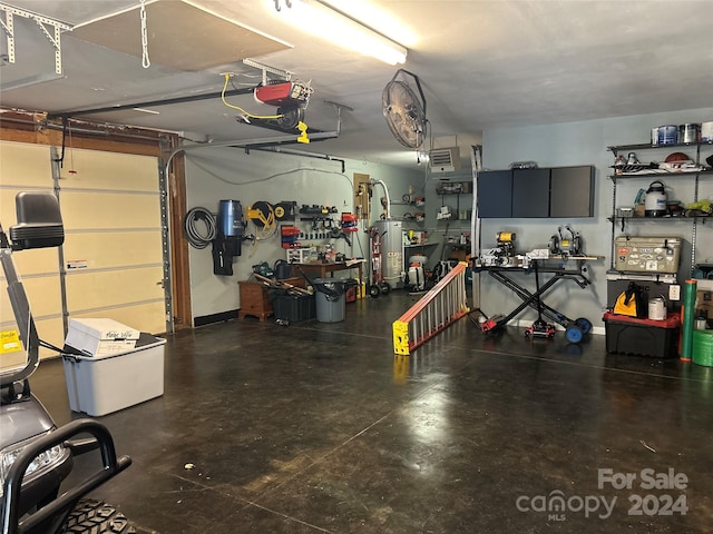 garage featuring a garage door opener and gas water heater