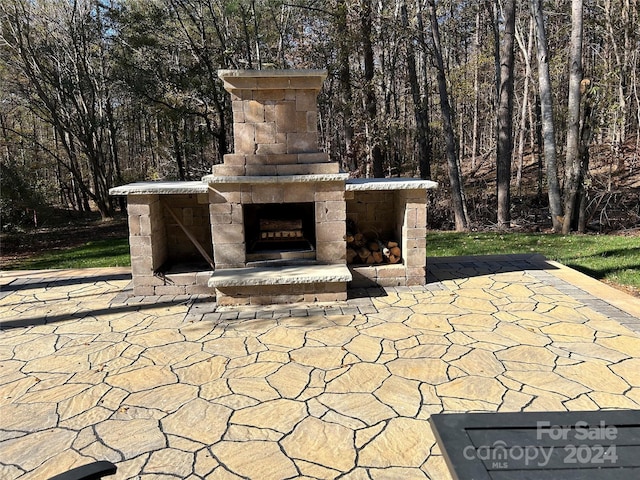 view of patio with an outdoor stone fireplace