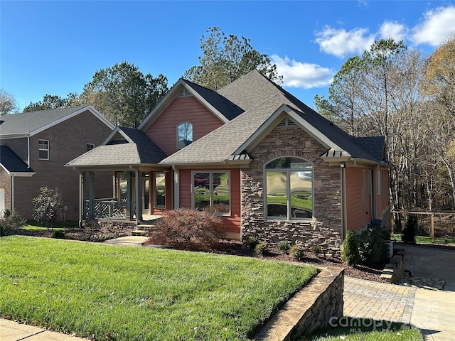 view of front of property with covered porch and a front lawn