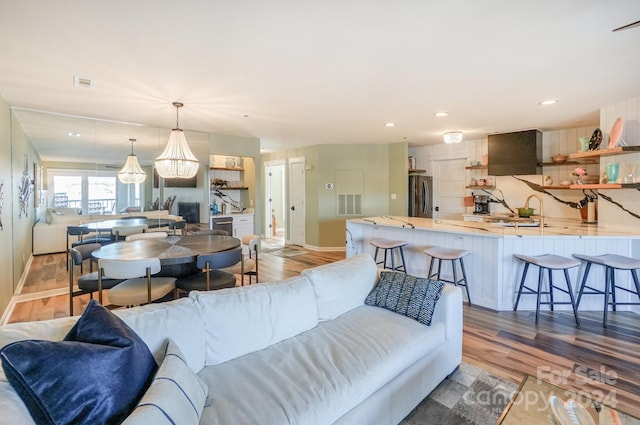 living room featuring dark hardwood / wood-style flooring and sink