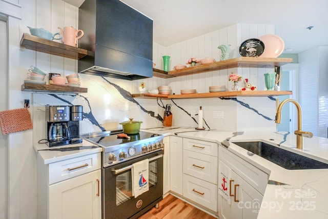 kitchen with open shelves, stainless steel stove, a sink, backsplash, and exhaust hood