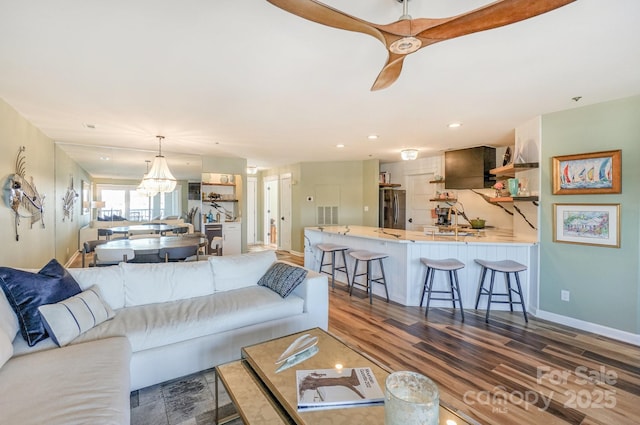 living area featuring recessed lighting, baseboards, ceiling fan, and dark wood finished floors