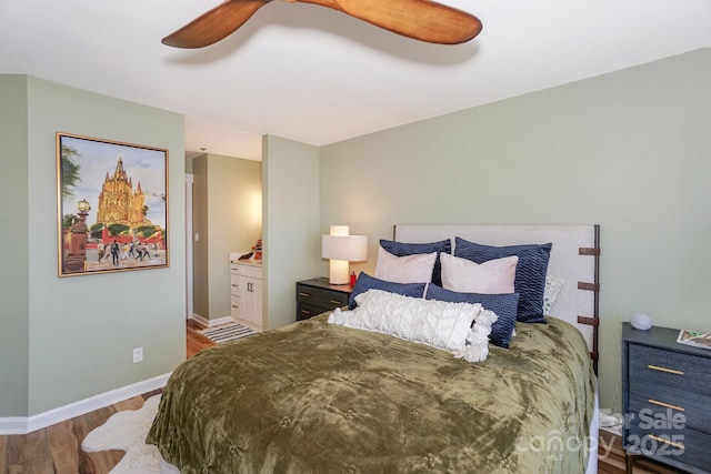 bedroom with baseboards, a ceiling fan, wood finished floors, and connected bathroom
