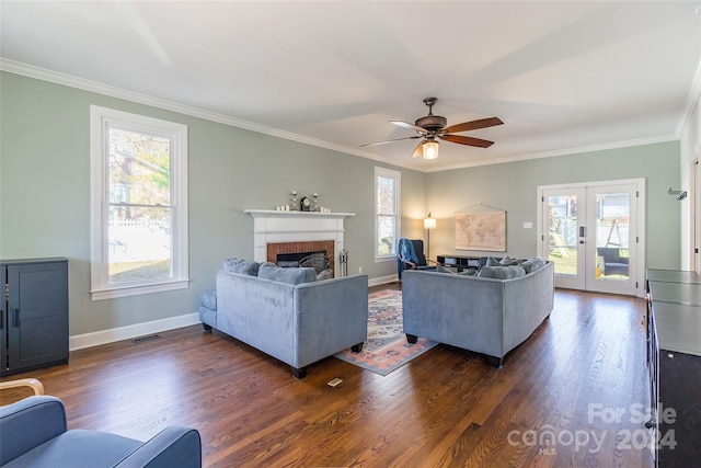 living room featuring french doors, ornamental molding, ceiling fan, a fireplace, and dark hardwood / wood-style floors