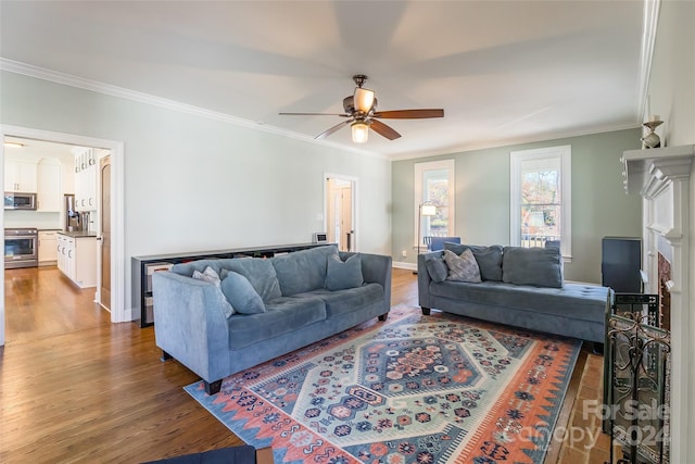 living room with ceiling fan, hardwood / wood-style floors, and crown molding