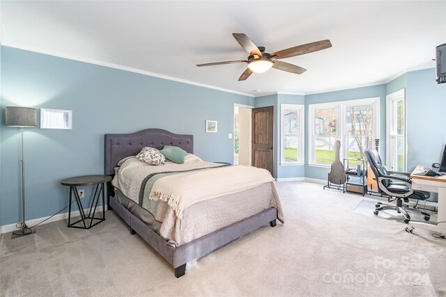 bedroom with ceiling fan, light colored carpet, and ornamental molding