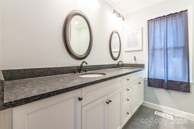 bathroom featuring tile patterned floors, crown molding, and vanity