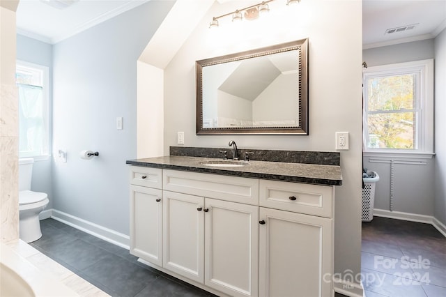 bathroom featuring toilet, tile patterned floors, and ornamental molding