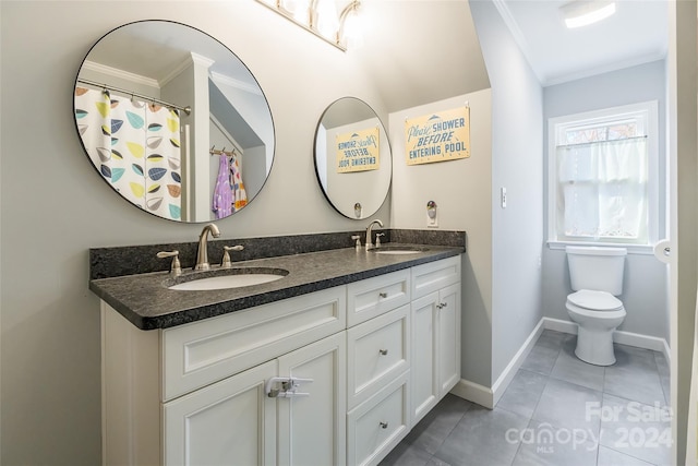 bathroom featuring toilet, vanity, tile patterned floors, and crown molding