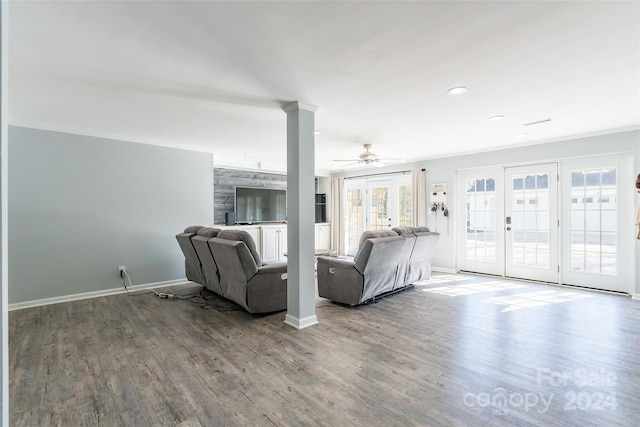 unfurnished living room featuring french doors, hardwood / wood-style flooring, ceiling fan, and ornamental molding