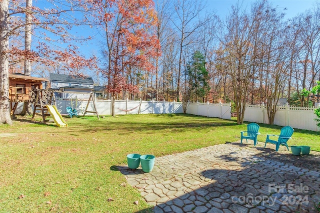 view of yard featuring a patio and a playground